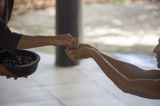 Devotee receiving prasad