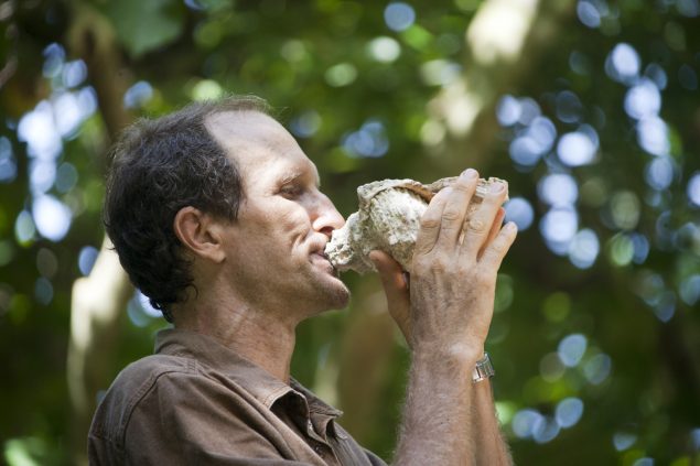 Devotee blowing conch shell